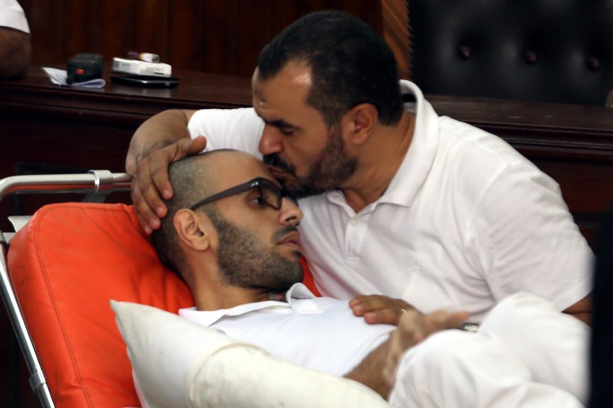 Muslim Brotherhood official Salah Soltan cares for his son, Mohamed Soltan, on Oct. 15, 2014, as the young man conducts a hunger strike in Cairo.