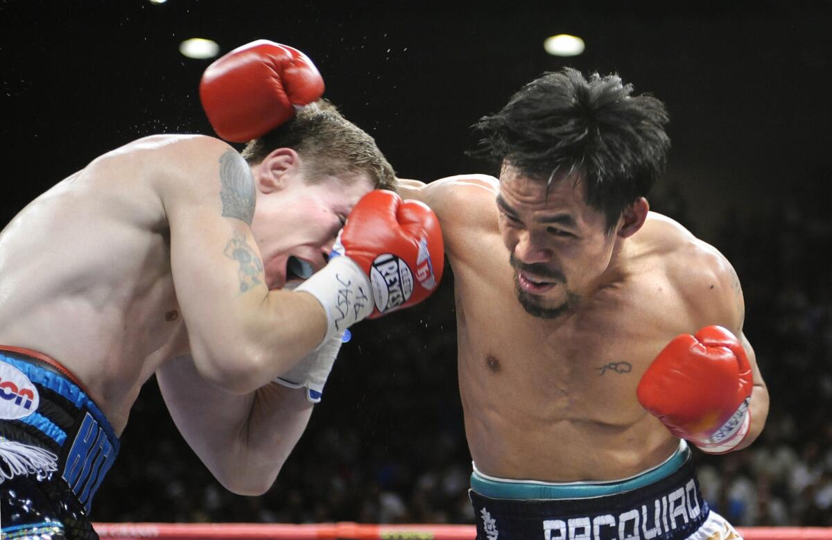 Manny Pacquiao lands a punch to Ricky Hatton in the second round of their fight.