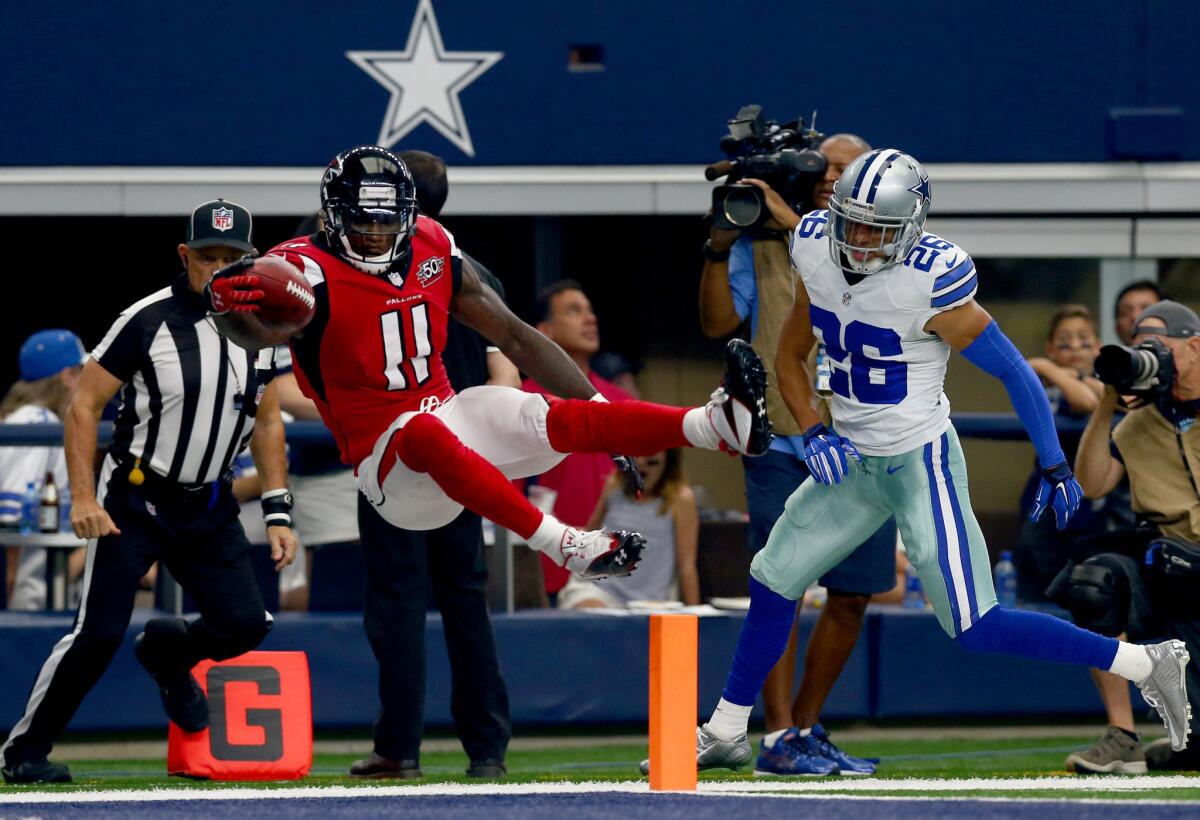 Falcons receiver Julio Jones leaps over the goal line to score a touchdown as Tyler Patmon of the Dallas Cowboys during a game on Sept. 27.