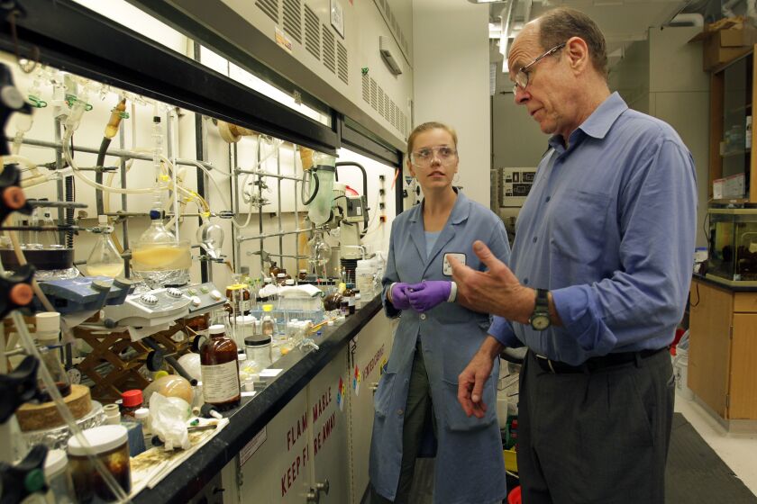 | Barry Sharpless, W. M. Keck professor of chemistry at The Scripps Research Institute, taks with Larissa Krasnova from the Fokin Research Group at his lab on Tuesday, Sept. 27, 2011. | (Photo by K.C. Alfred - The San Diego Union-Tribune)