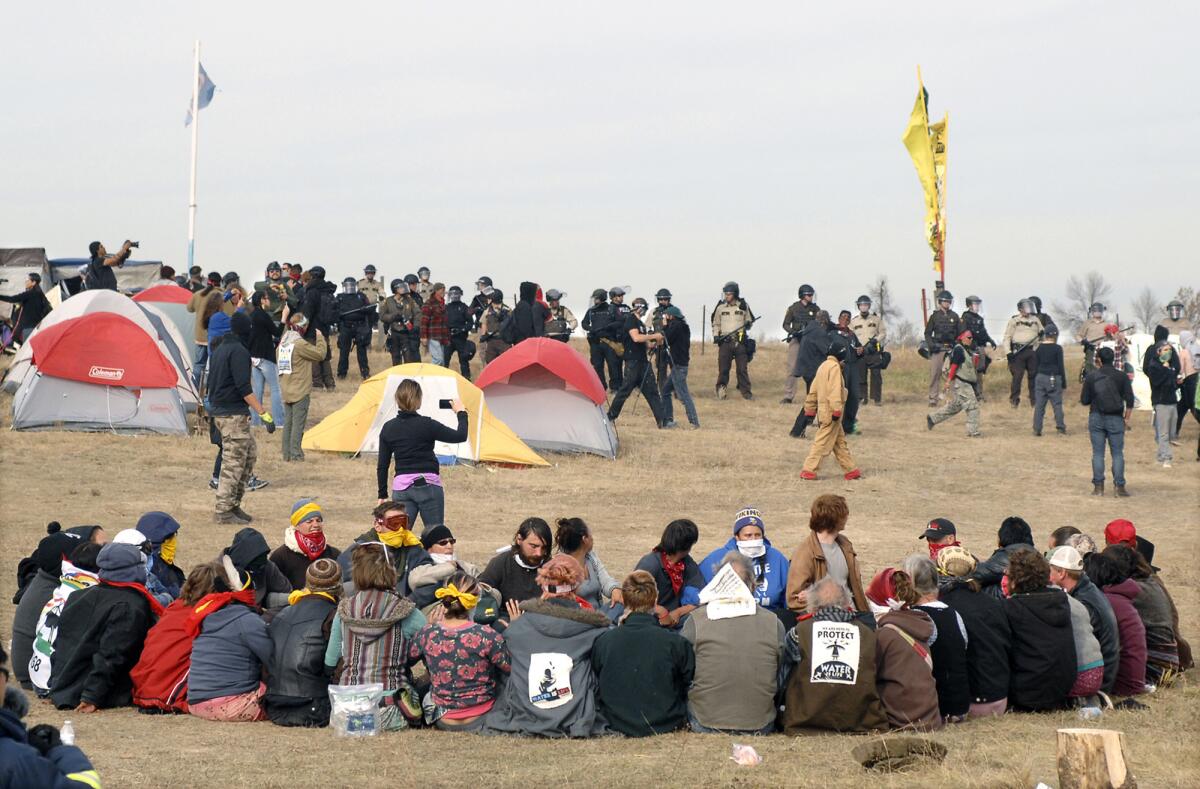 Dakota Access pipeline protesters sit in a prayer circle as law enforcement officers prepare to remove them on Oct. 27, 2016.