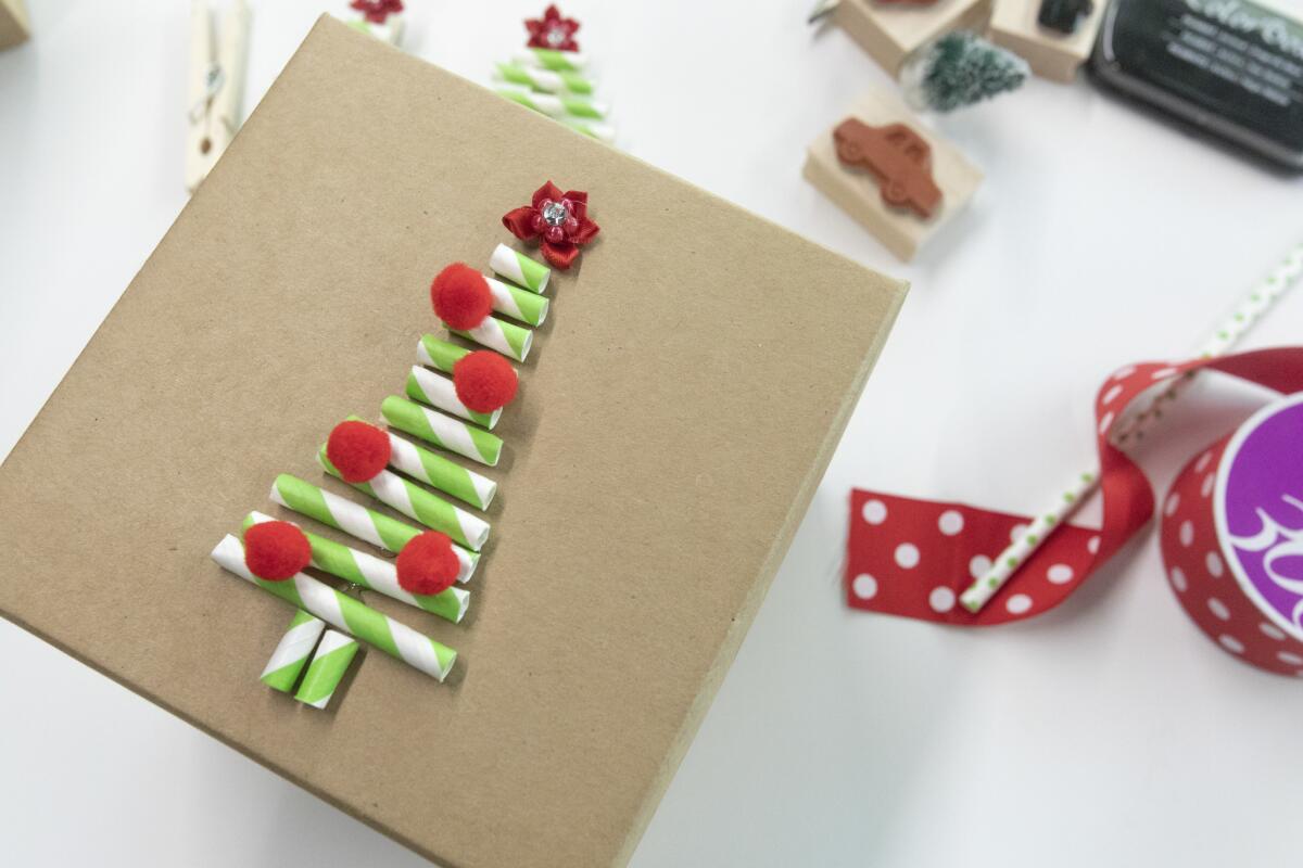 Use decorative straws to create a Christmas tree motif that turns a gift box into its own special present.