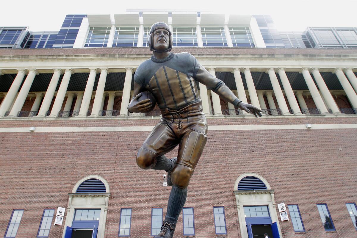 A statue of Hall of Fame halfback Red Grange stands outside University of Illinois Memorial Stadium.