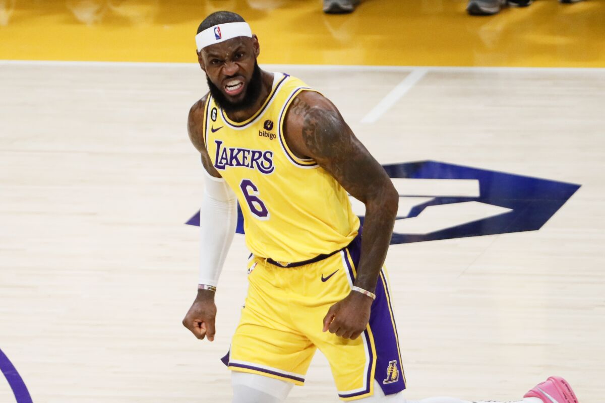 Lakers forward LeBron James sneers after making a three-point shot.