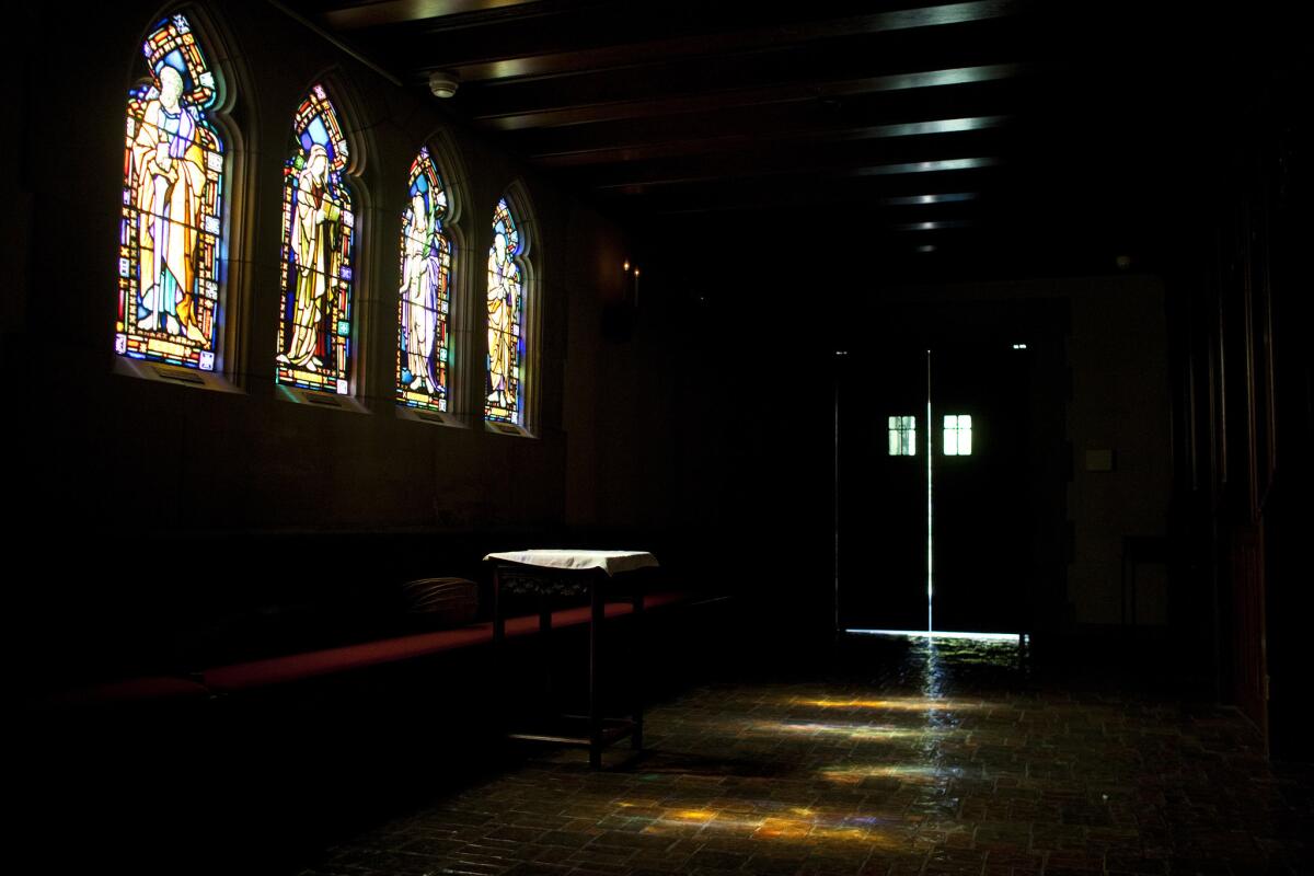 Light from the stained-glass windows dances on the floor inside All Saints Church on North Euclid.