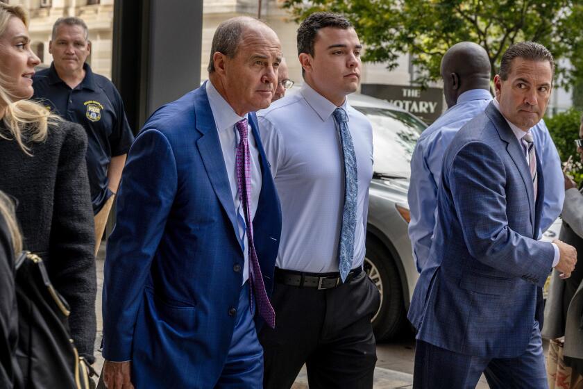 FILE - Philadelphia police Officer Mark Dial, center, arrives at the Juanita Kidd Stout Center for Criminal Justice in Philadelphia, Sept. 19, 2023, with attorneys Brian McMonagle, left and Fortunato Perri, right, for a bail hearing. Lawyers for Dial, who shot and killed a driver, will press to have the murder charges lodged against him dismissed when the jailed officer appears in court, Tuesday, Sept. 26. (Tom Gralish/The Philadelphia Inquirer via AP, File)