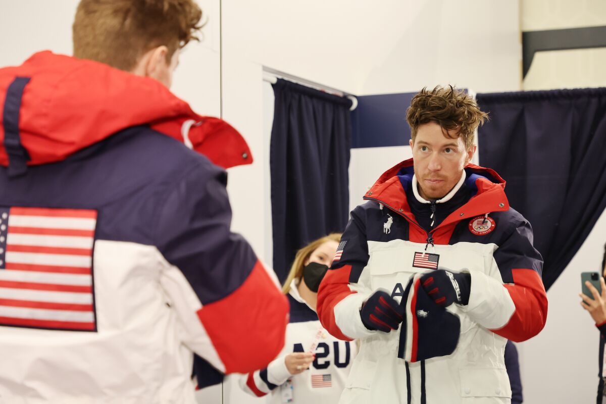 Shaun White looks into a mirror while being fitted in Polo Ralph Lauren gear