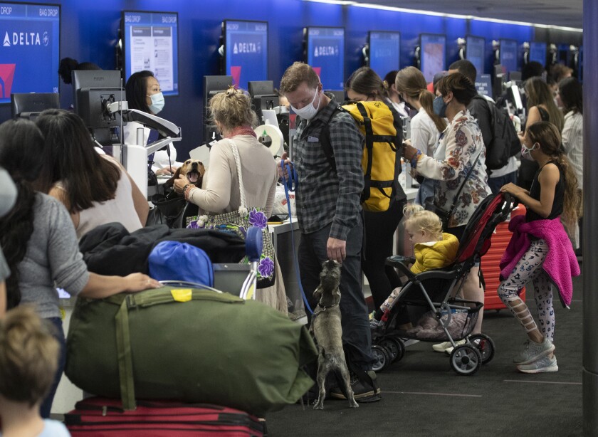 Air travelers prepare for a last dash of summer travel amid a surge in coronavirus cases.
