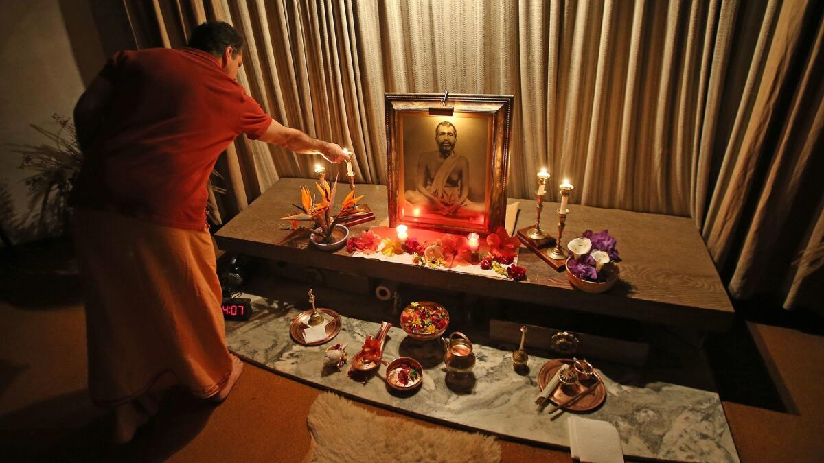 Swami Dhyanayogananda lights candles on the Sri Ramakrishna shrine at the Ramakrishna Monastery in Trabuco Canyon. TimesOC reporter Ben Brazil took fourth place in feature writing for a story about the monastery.