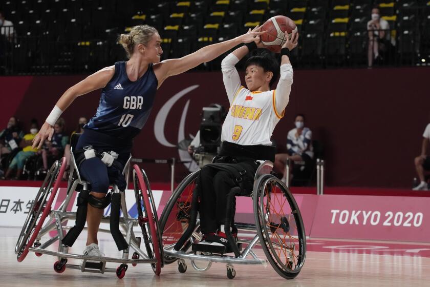 FILE - Britain's Amy Conroy (10) and China's Lin Suiling (9) battle for the ball during women's wheelchair basketball quarterfinal game at the Tokyo 2020 Paralympic Games, Tuesday, Aug. 31, 2021, in Tokyo, Japan. (AP Photo/Kiichiro Sato, File)