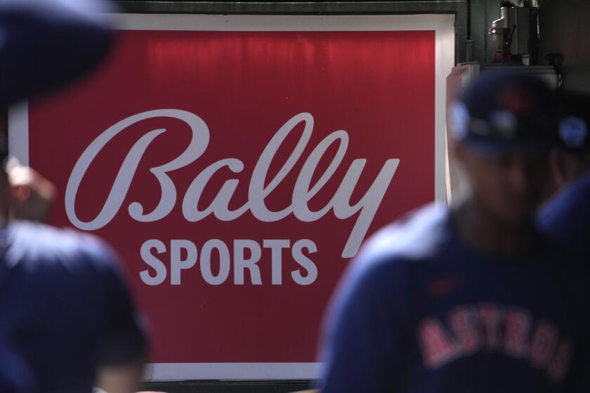 A Bally Sports sign hangs in a dugout before the start of a spring training baseball game between the St. Louis Cardinals and Houston Astros Thursday, March 2, 2023, in Jupiter, Fla. (AP Photo/Jeff Roberson)