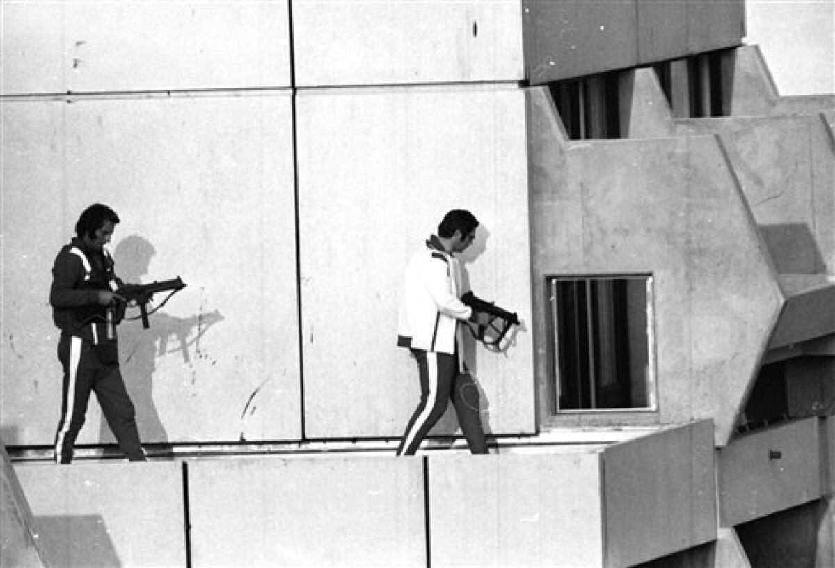 FILE - In this Sept. 5, 1972, file photo, two west German policemen, armed with submachine guns and wearing athletes tracksuits, get into position on the roof of the building where armed Palestinian terrorists are holding Israel Olympic team members hostage. (AP Photo/File) ISRAEL OUT