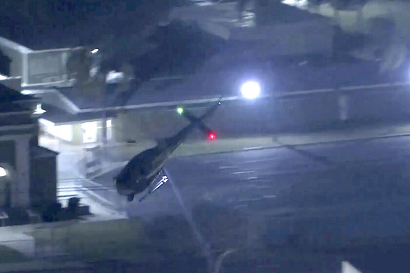 An investigation underway after a man authorities say was under the influence and firing from a rooftop at a Los Angeles County sheriff's helicopter with a shotgun was killed by deputies on June 13 in Compton.