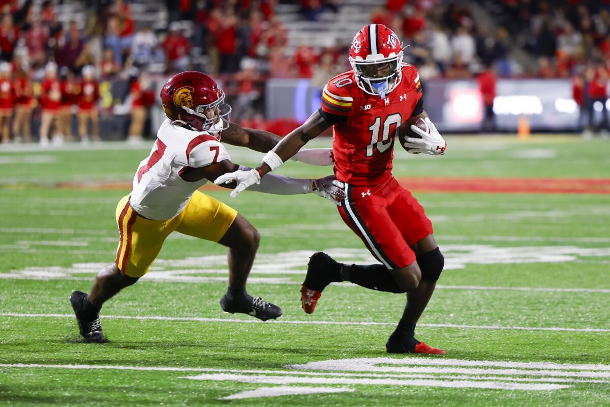 Maryland wide receiver Tai Felton runs past USC safety Kamari Ramsey to score a touchdown.