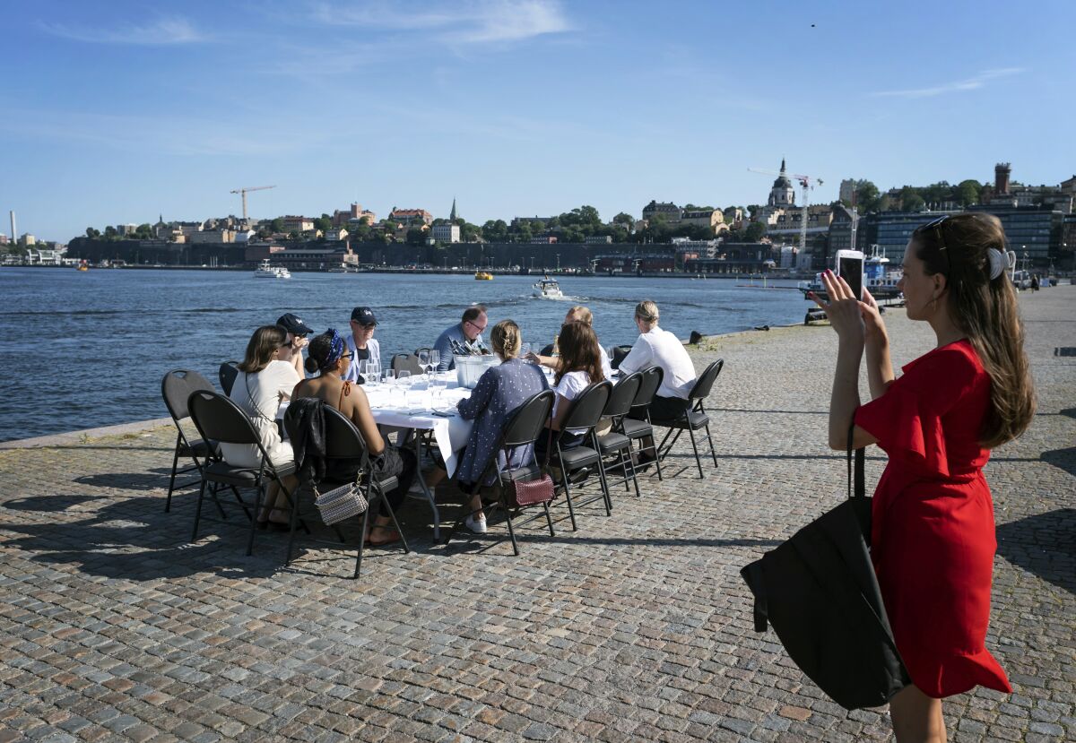 People socially distance as they have a drink after work, in Stockholm