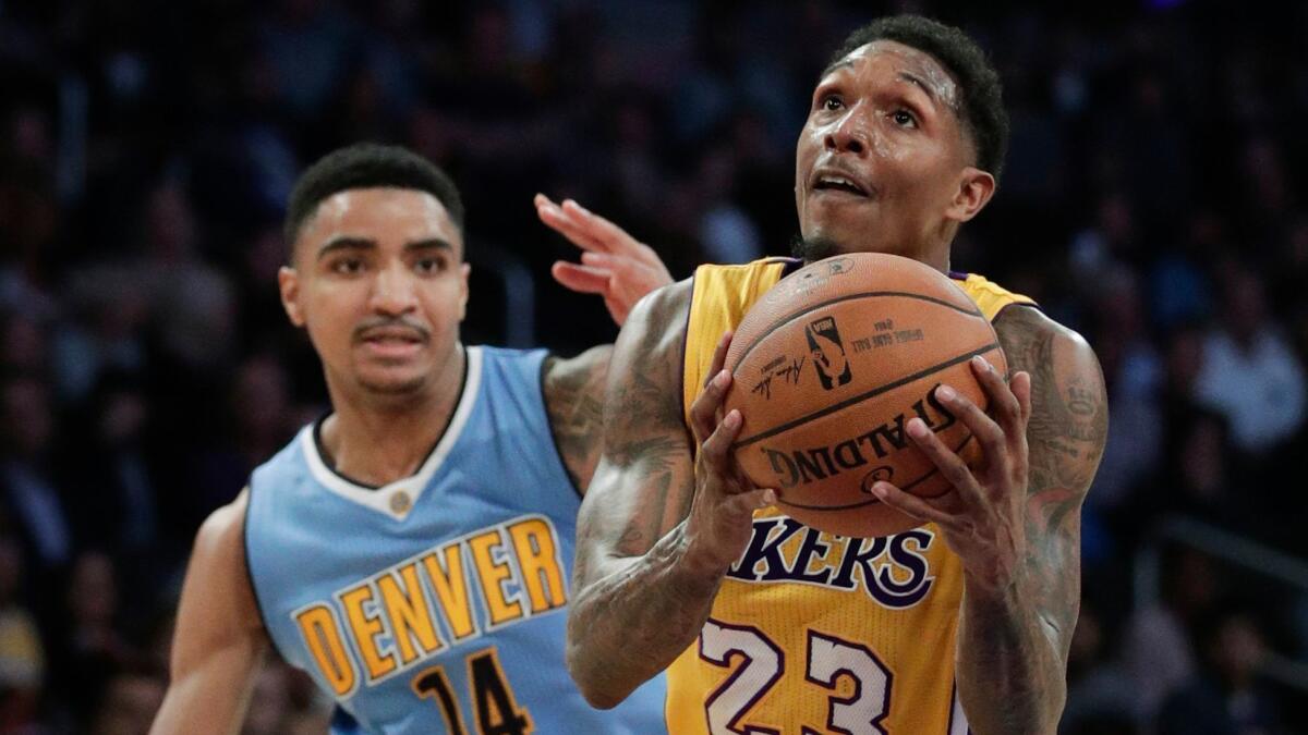 Lakers' Lou Williams drives to the basket past Denver's Gary Harris on Jan. 31 at Staples Center.
