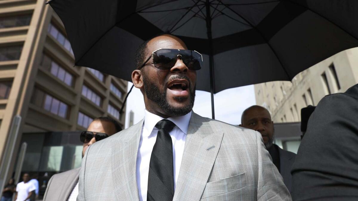 Musician R. Kelly leaves court in Chicago after pleading not guilty to sex-related charges in June.
