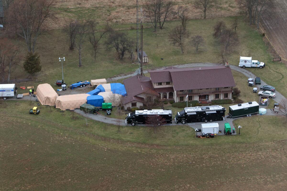 In this aerial photo taken from WTHR Chopper 13, FBI agents work around the home of 91-year-old Donald Miller in Waldron, Ind. Authorities seized thousands of Native American, Russian, Chinese and other artifacts that have "immeasurable" cultural value from Miller's private collection, the FBI said.