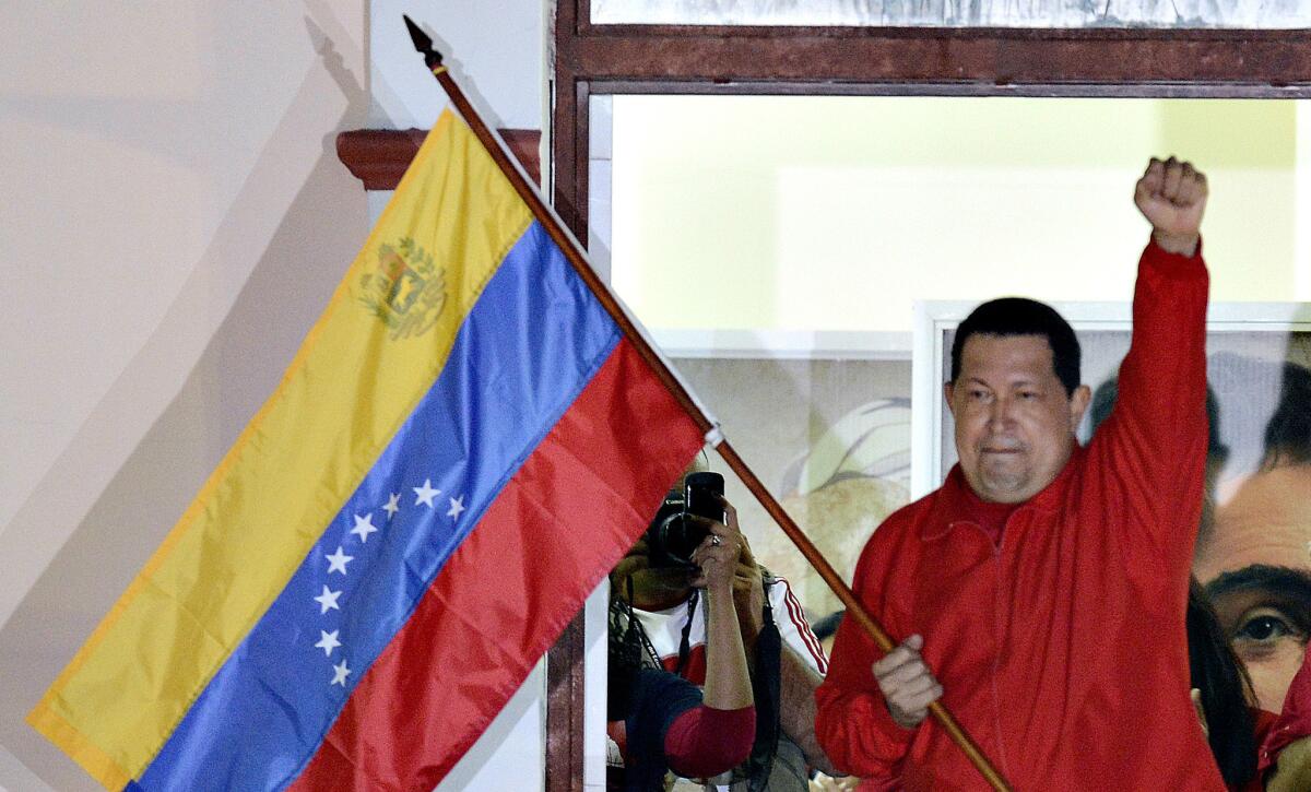 Then-Venezuelan President Hugo Chavez raises his fist while speaking to supporters after his reelection in Caracas on Oct. 7, 2012.