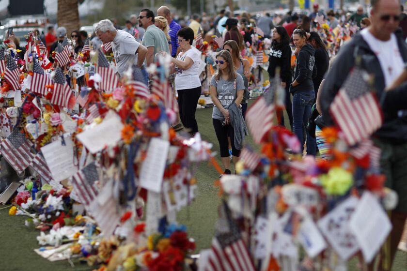 FILE - People visit a makeshift memorial honoring the victims of the Oct. 1, 2017, mass shooting in Las Vegas, on Nov. 12, 2017. Five years after a gunman killed 58 people and wounded hundreds more at a country music festival in Las Vegas, in the deadliest mass shooting in modern U.S. history, the massacre is now part of a horrifying increase in the number of mass slayings with more than 20 victims, according to a database of mass killings maintained by The Associated Press, USA Today and Northeastern University. (AP Photo/John Locher, File)