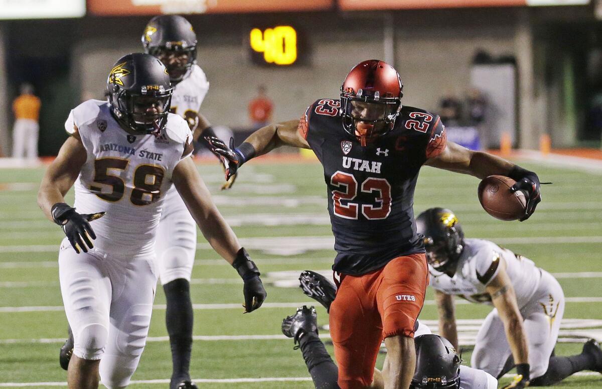Utah running back Devontae Booker carries the ball as Arizona State linebacker Salamo Fiso (58) pursues during the first half of a game on Oct. 17.