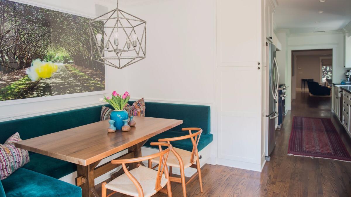 After: Lara Sachs-Fishman chose durable mohair upholstery for seating in the kitchen. The pendant is from Noir. (Christina House / For The Times)