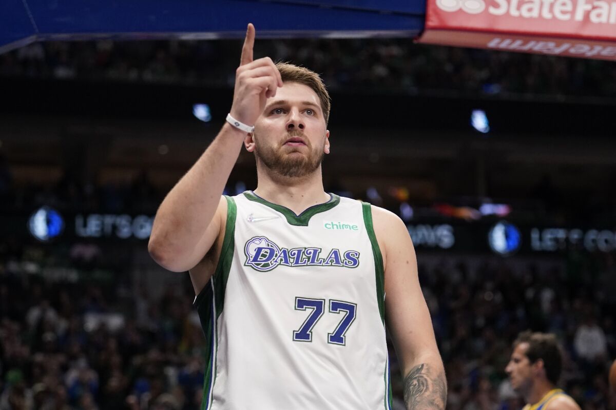 Dallas Mavericks' Luka Doncic celebrates after being fouled sinking a basket in the first half of an NBA basketball game agains the Golden State Warriors in Dallas, Thursday, March, 3, 2022. (AP Photo/Tony Gutierrez)
