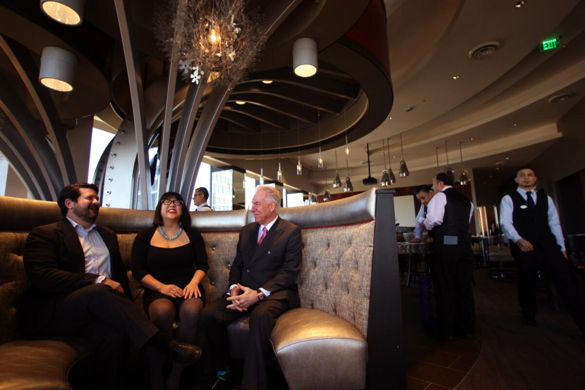 Club members Todd and Sian Seligman, left, and City Club General Manager Larry Ahlquist enjoy a light moment inside the club's new location.