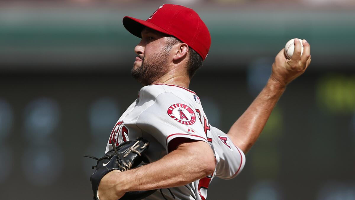 Angels closer Huston Street delivers a pitch in the ninth inning of the team's 3-2 loss to the Texas Rangers on Sunday.
