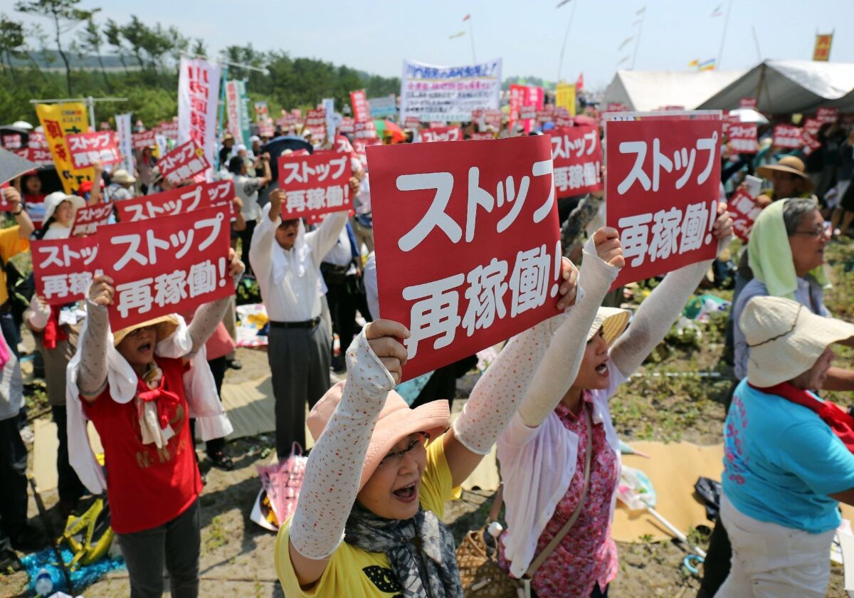 Protesters rally Aug. 9 on Japan's southern island of Kyushuanti against the decision to restart a reactor at the Kyushu Electric Power Co.'s Sendai nuclear plant.