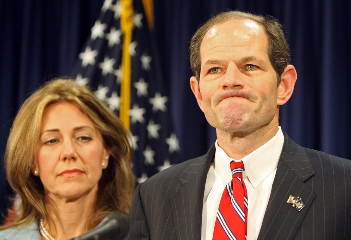 Then-Gov. Eliot Spitzer of New York, with his wife, Silda, apologizes to the public on March 10, 2008, in New York City.
