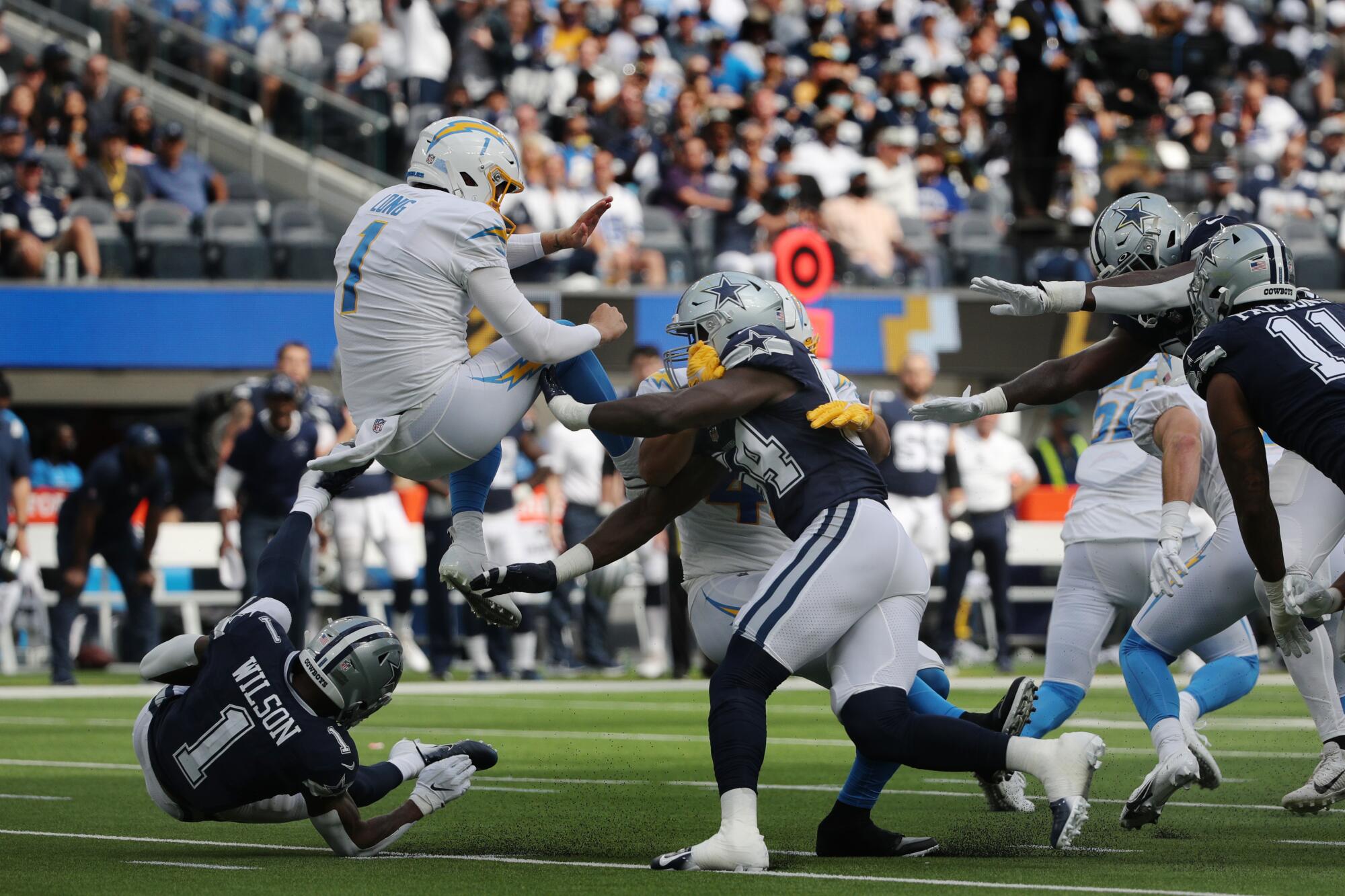 Dallas Cowboys defensive end Azur Kamara is penalized for roughing Chargers punter Ty Long.