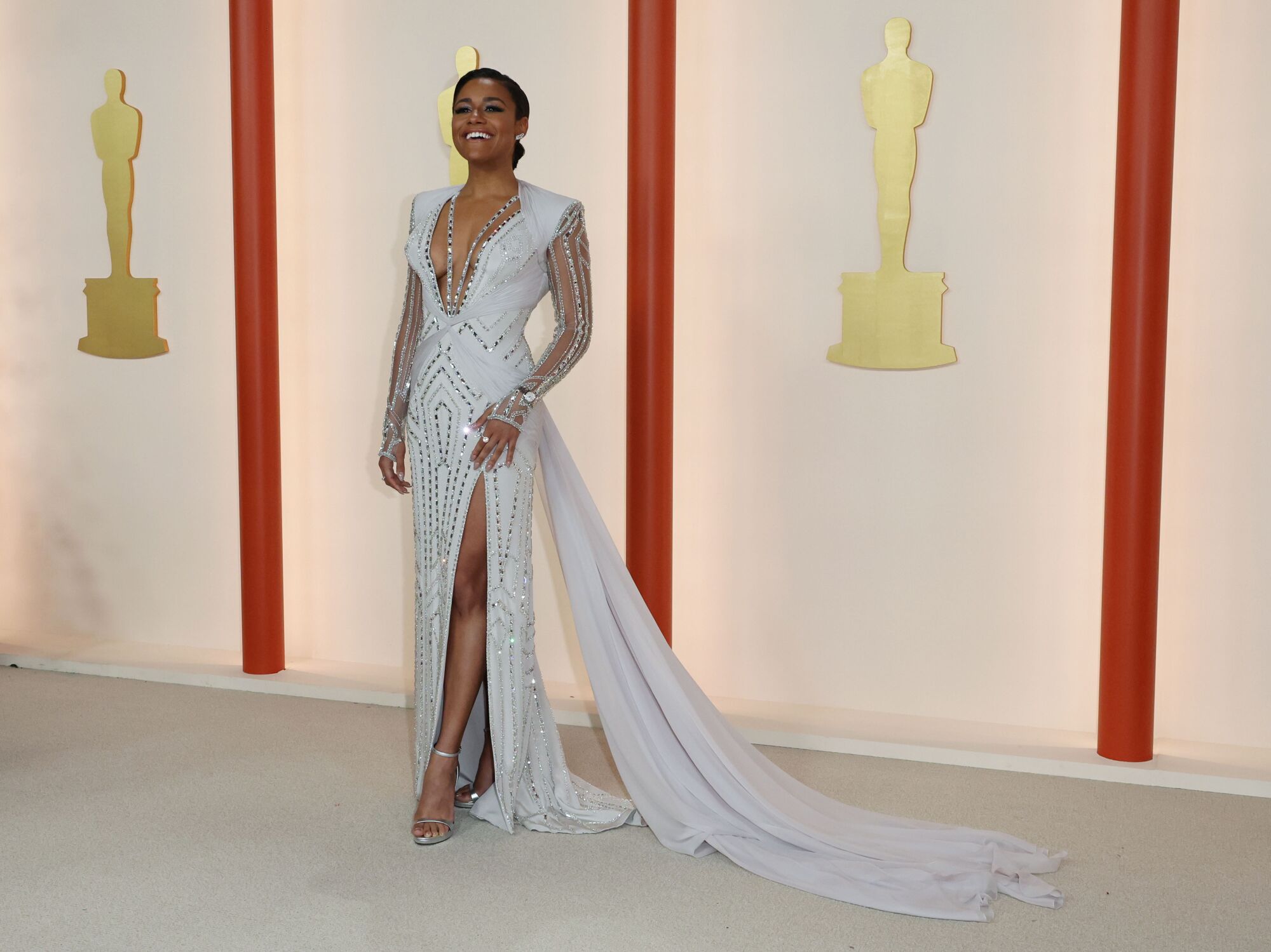 Ariana DeBose in a sparkling white gown studded in an Art Deco geometric pattern with silver studs.
