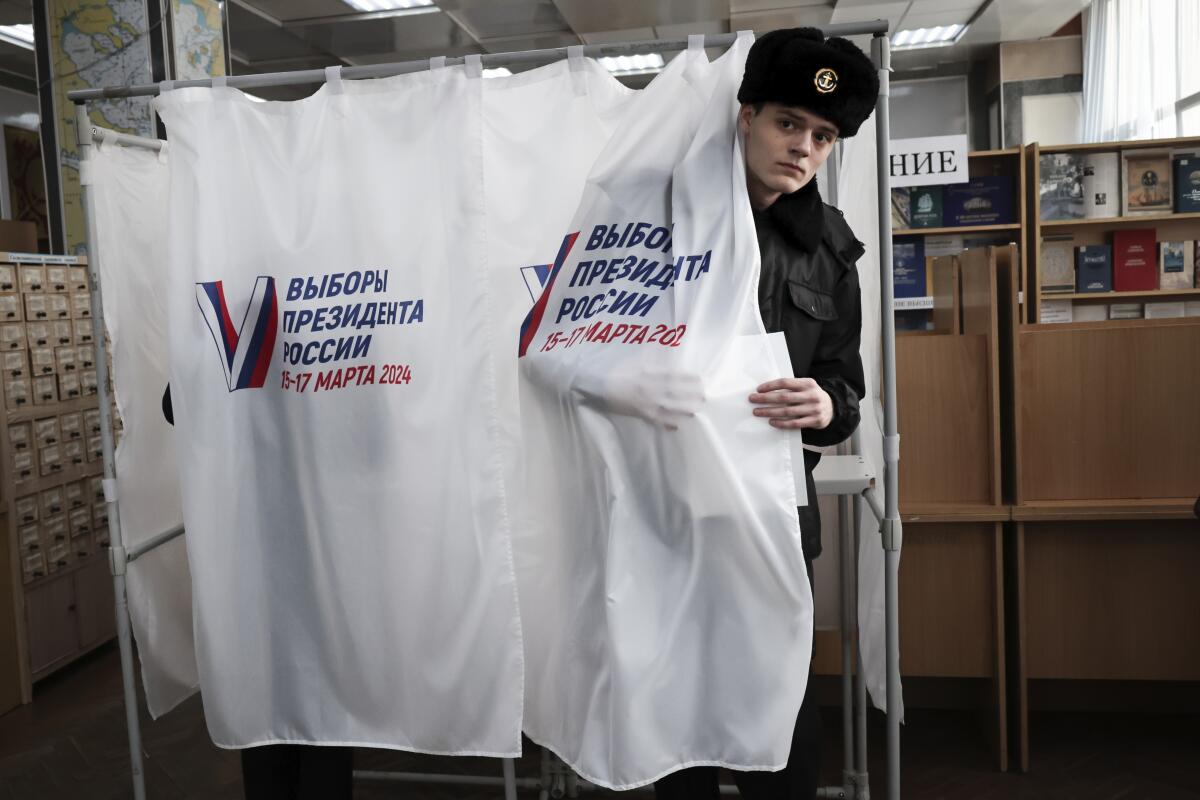 A soldier emerges from a voting booth