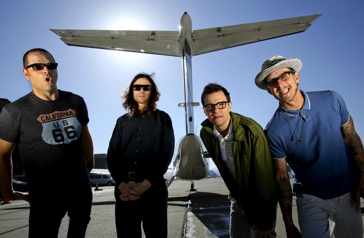 Patrick Wilson, left, Brian Bell, Rivers Cuomo and Scott Shriner of Weezer on the tarmac at Hawthorne Airport last year.