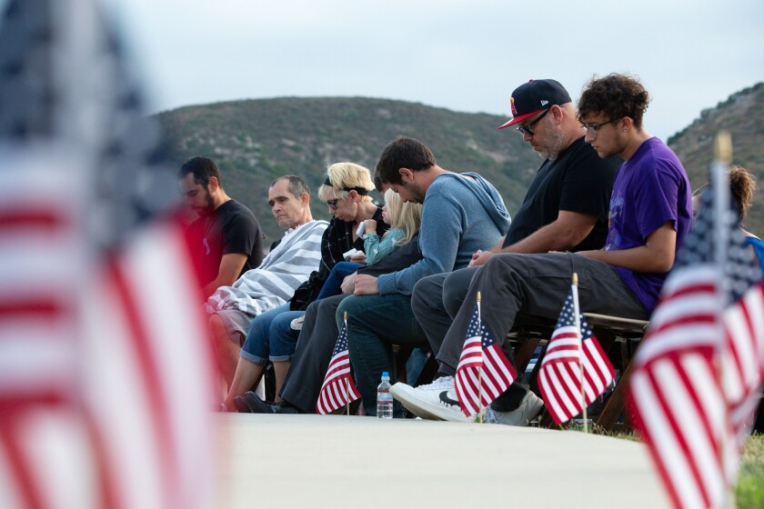 Friends and family gathered Sunday for a vigil at Fourth of July Community Park in Escondido to honor the detectives. 
