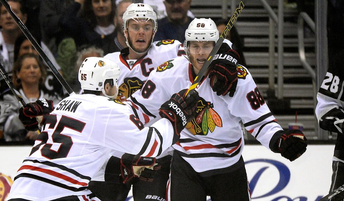 Blackhawks winger Patrick Kane (88) celebrates his goal in the second period with teammates Andrew Shaw (65) and Jonathan Toews (19) in Game 6 on Friday night at Staples Center.