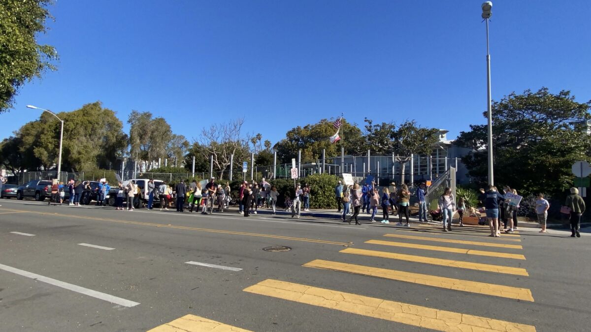About 100 people participated in a Feb. 18 protest in La Jolla against continued school closures.