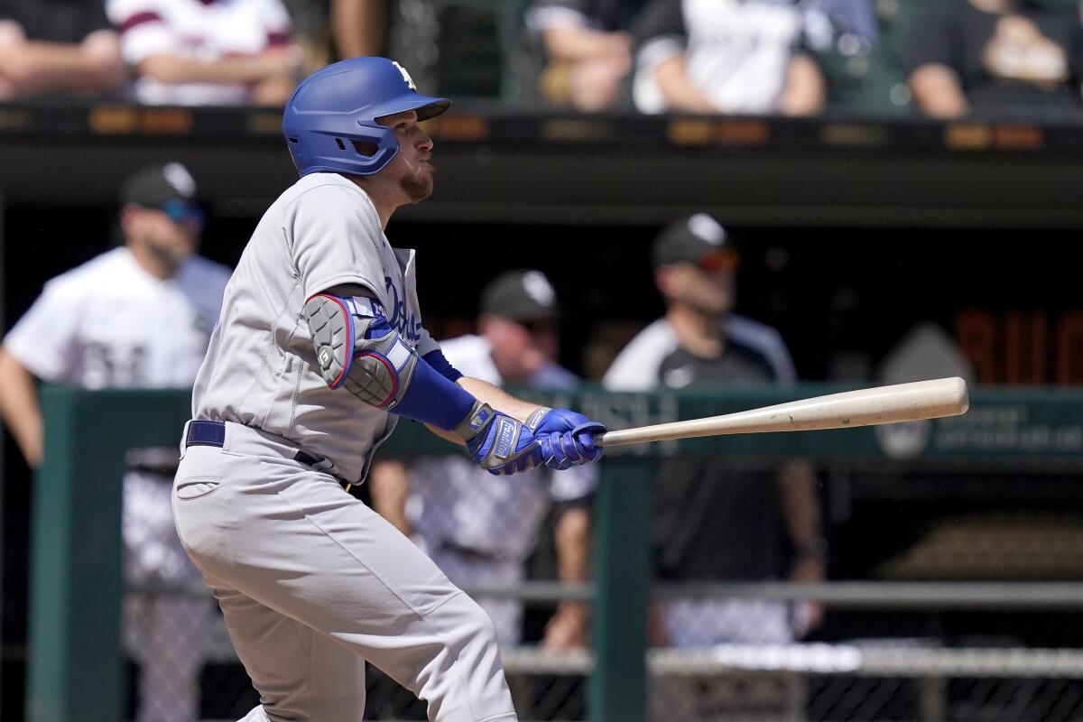 Dodgers' Max Muncy watches his two-run double off Chicago White Sox pitcher Dylan Cease.