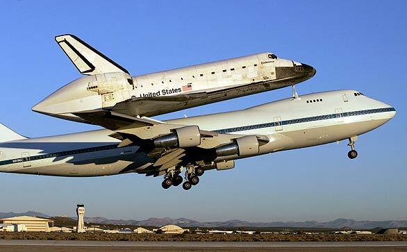 The space shuttle Endeavour takes off from Edwards Air Force Base piggybacked to a modified 747 on its way back to the Kennedy Space Center in Florida.