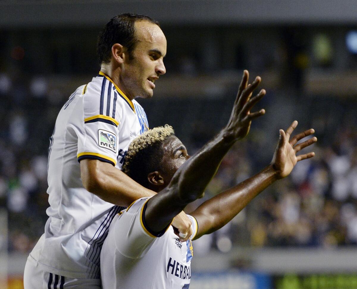 Landon Donovan jumps onto the shoulders of Gyasi Zardes after his goal in the 29th minute of the Galaxy's 2-2 draw with the San Jose Earthquakes.