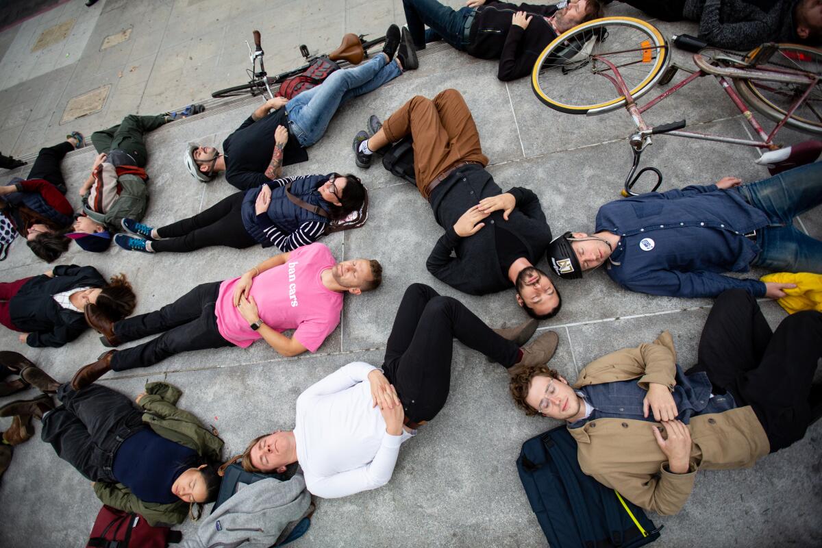 Advocates staging a "die-in" on the steps of L.A. City Hall in December to protest a lack of progress on the city's goal of eliminating traffic deaths on city streets by 2025.