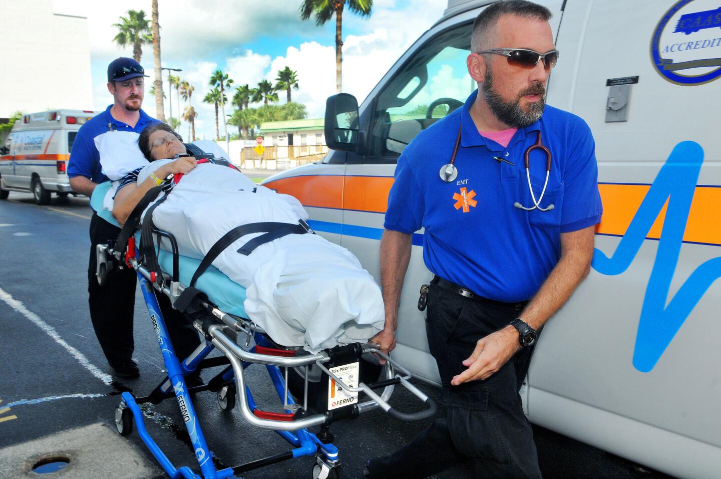 Keith Nelson and Jason Greene with Coastal Health Systems ambulance service evacuate patient Linda LaPorta from the Cape Canaveral Hospital in Cocoa Beach, Fla., on Oct. 5, 2016, as they prepare for the impact of hurricane Matthew.