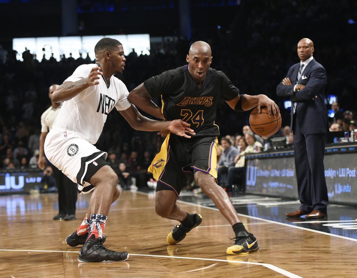 Kobe Bryant tries to drive against Nets forward Joe Johnson during a game on Nov. 6.