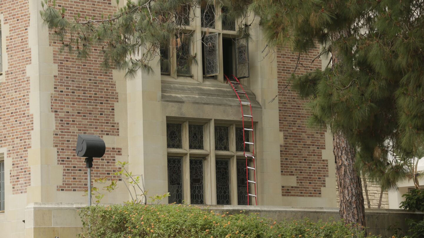 A ladder hangs out a window after a shooting at UCLA on Wednesday morning.