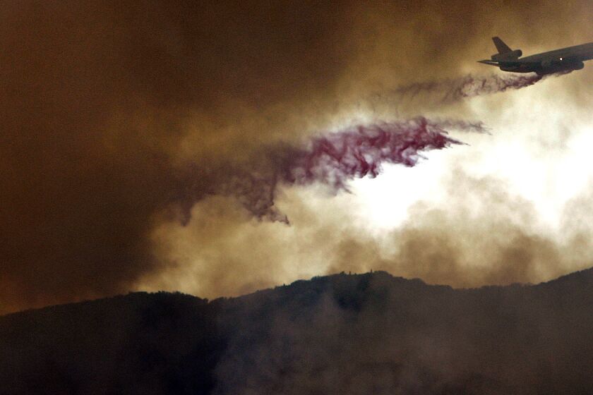 A converted DC-10 jumbo jet drops fire retardant on a brush fire near Corral Canyon in Malibu in November. The plane is part of the California Department of Forestry and Fire Protection fleet of aircraft, which includes two dozen tankers, 11 heavy-duty helicopters and 14 twin-engine command-and-control planes.