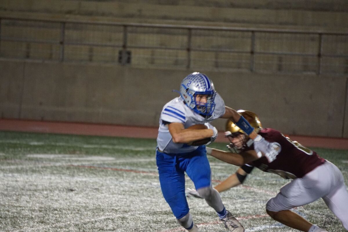 La Jolla Country Day's Jaden Mangini carries the ball against Bishop's last season. The teams will meet this year Oct. 7.