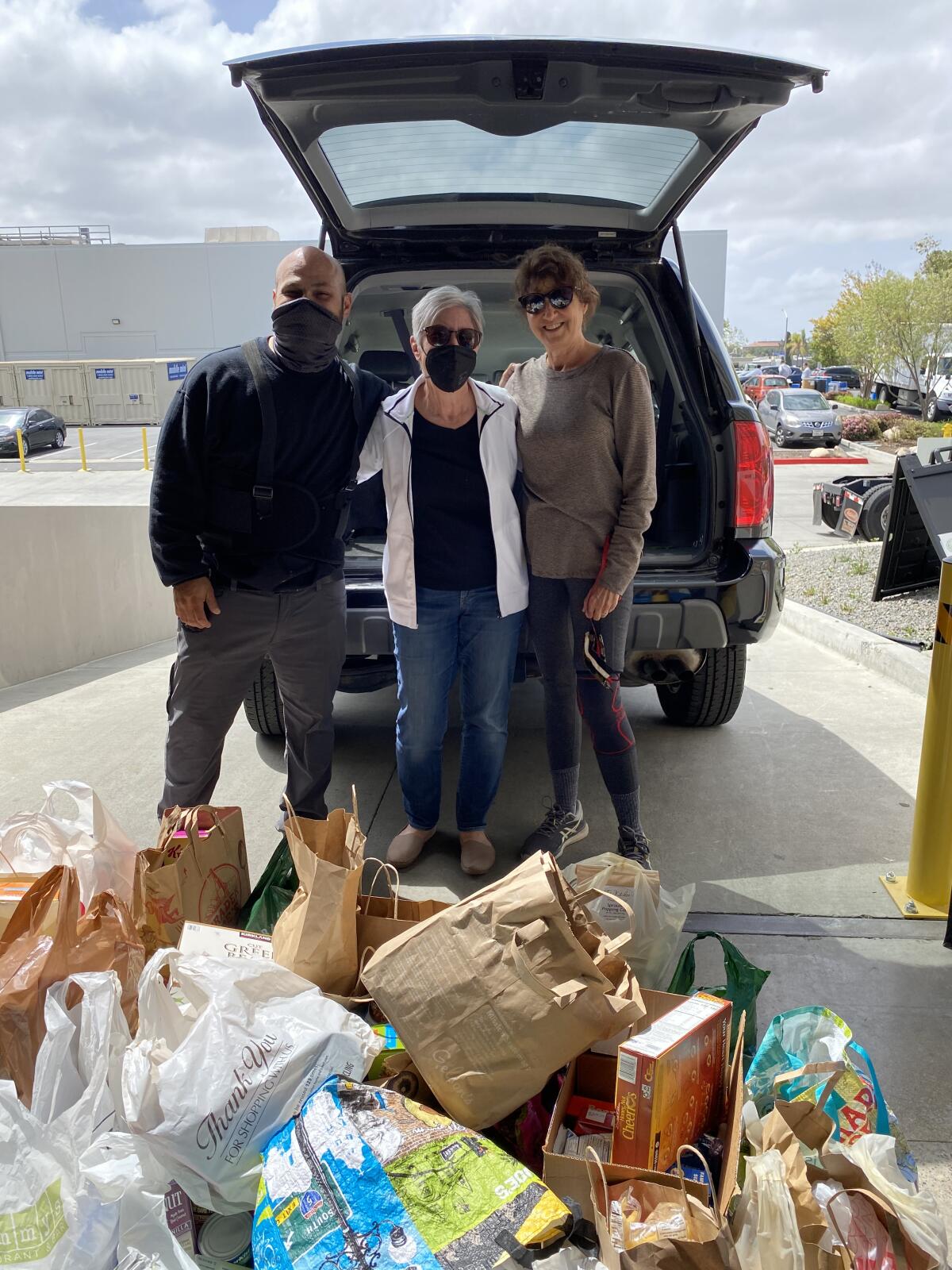 Judi Omson and Mimi Sells deliver donations from the La Jolla Newcomers Club to the San Diego Food Bank.