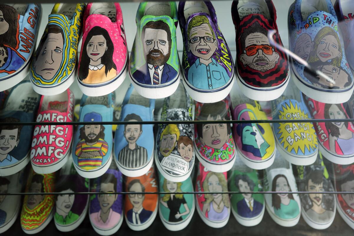 A display of tennis shoes painted with portraits of "Earwolf" podcast hosts is the work of podcast fan Charlie Malta, who goes by "Guice Mann." Comedy podcasting network Earwolf has expanded to include big-name talents, including Conan O'Brien.