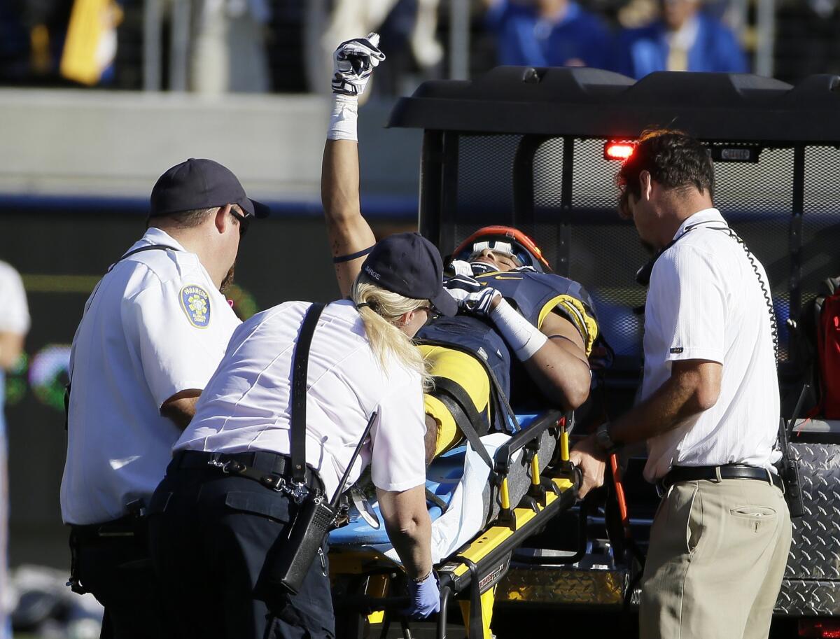 California receiver Trevor Davis gives the thumbs-up sign as he is carted off the field in the fourth quarter with a head injury.